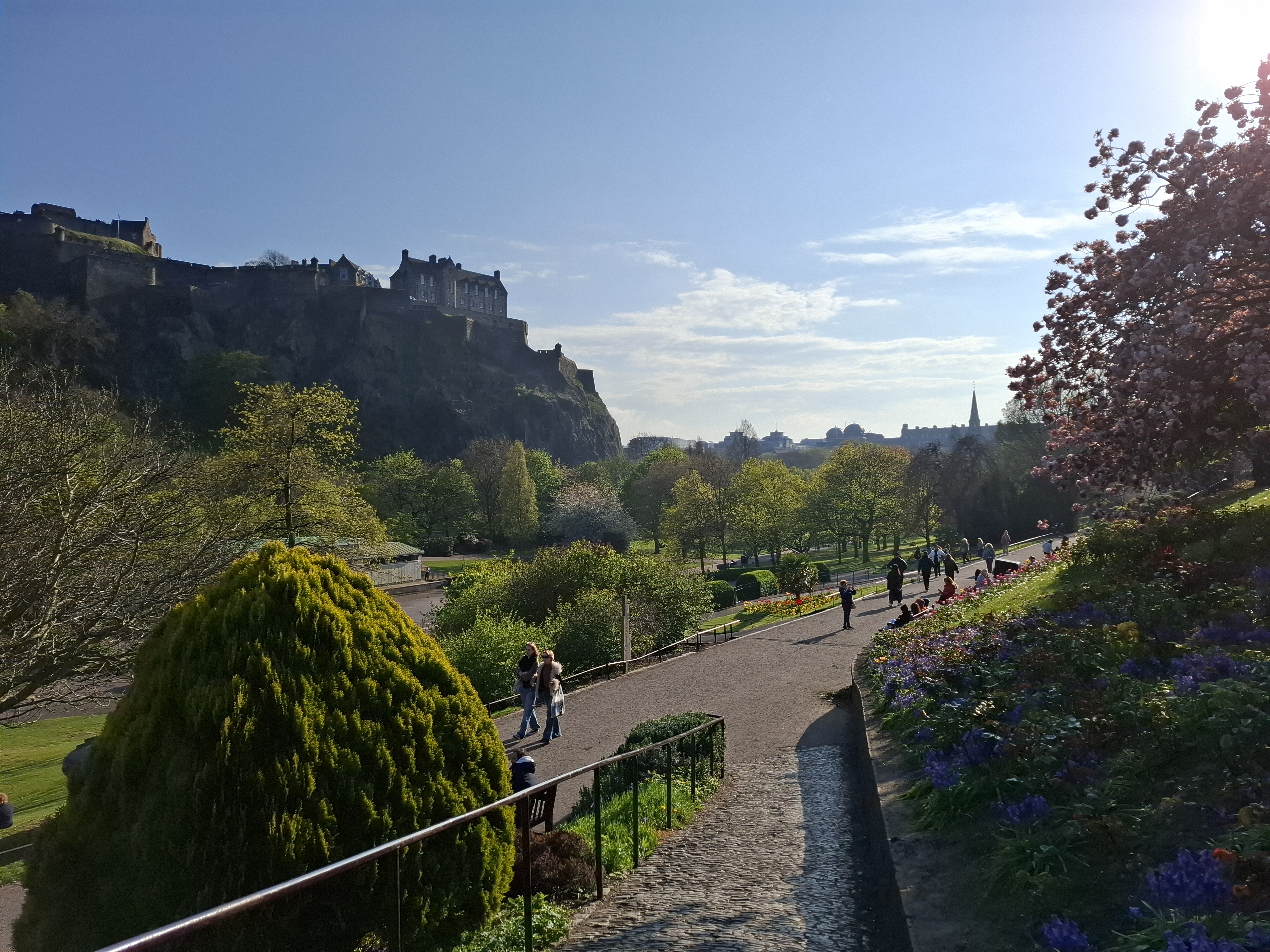 bright sunny view of blue sky over Edinburgh Castle and Princes Street Gardens